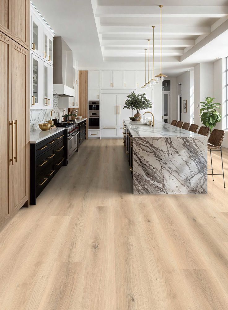 Bright contemporary kitchen with white cabinets, marble island, wooden cabinetry, and gold hardware.