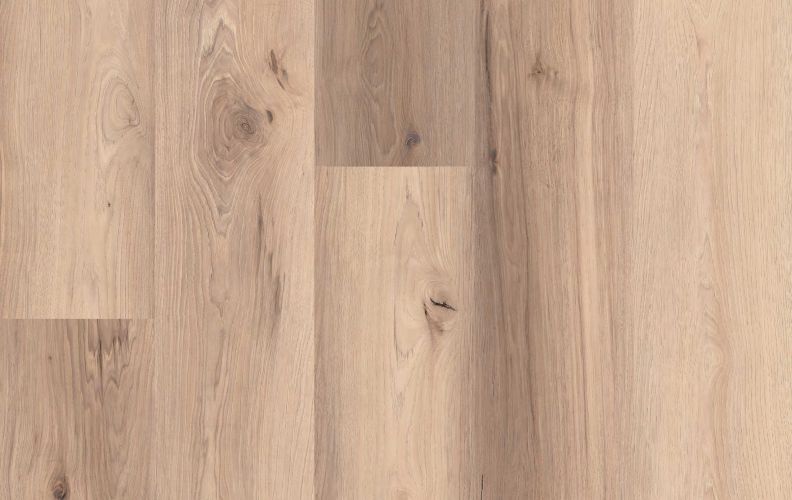 Light wooden floor with wide planks and natural grain patterns across the surface, showing knots and color variation.