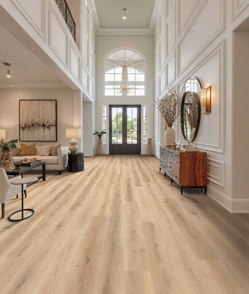 Grand two‑story entry hall with arched transom window above double doors, a chandelier, white paneled walls, and a wooden console with a round mirror on the right.