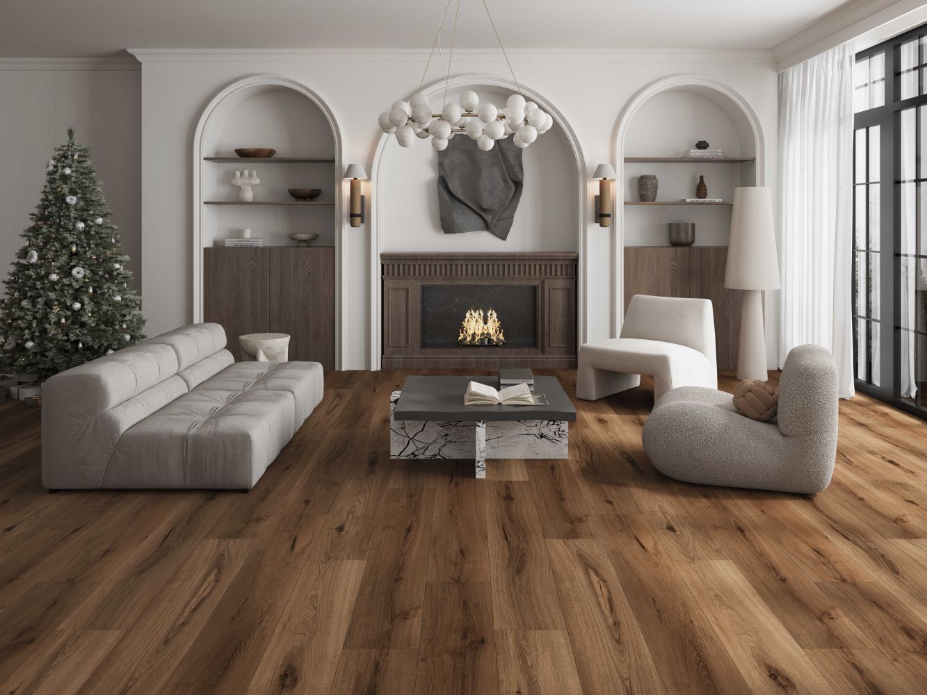 Bright living room with a dark wood fireplace flanked by arched alcoves, neutral seating, and a Christmas tree on the left. The space has a marble-topped coffee table and large windows on the right.