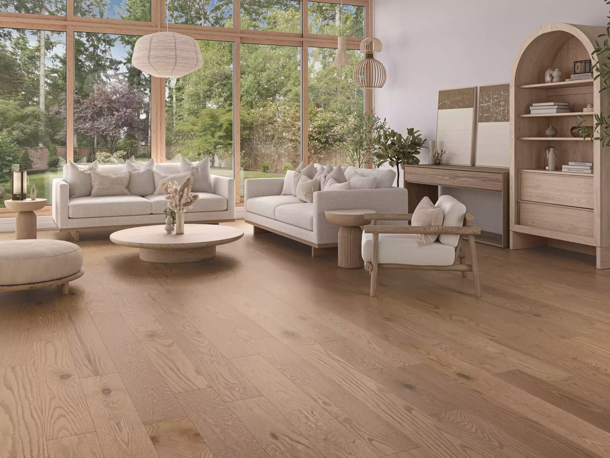 Bright airy living room with floor-to-ceiling windows, light wood furniture, white sofas, and greenery outside.